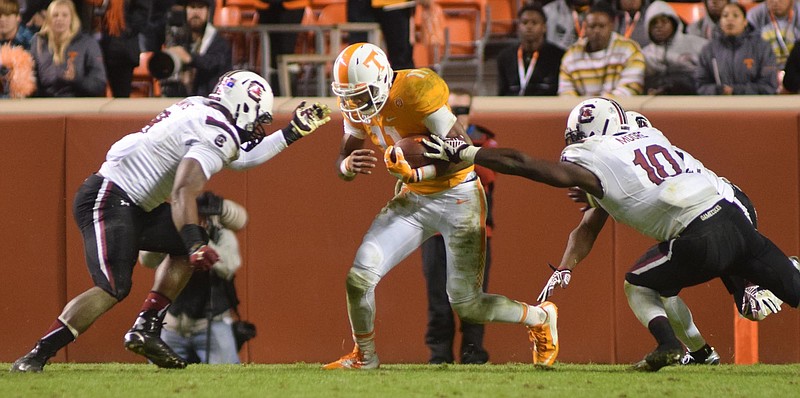 Tennessee quarterback Joshua Dobbs (11) is surrounded by Gamecock defenders.  The South Carolina Gamecocks visited the Tennessee Volunteers in SEC football action November 7, 2015.