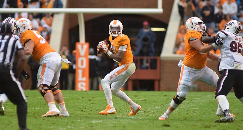 Tennessee quarterback Joshua Dobbs (11) looks to pass from behind the protection of the Volunteer offensive line.  The South Carolina Gamecocks visited the Tennessee Volunteers in SEC football action November 7, 2015.