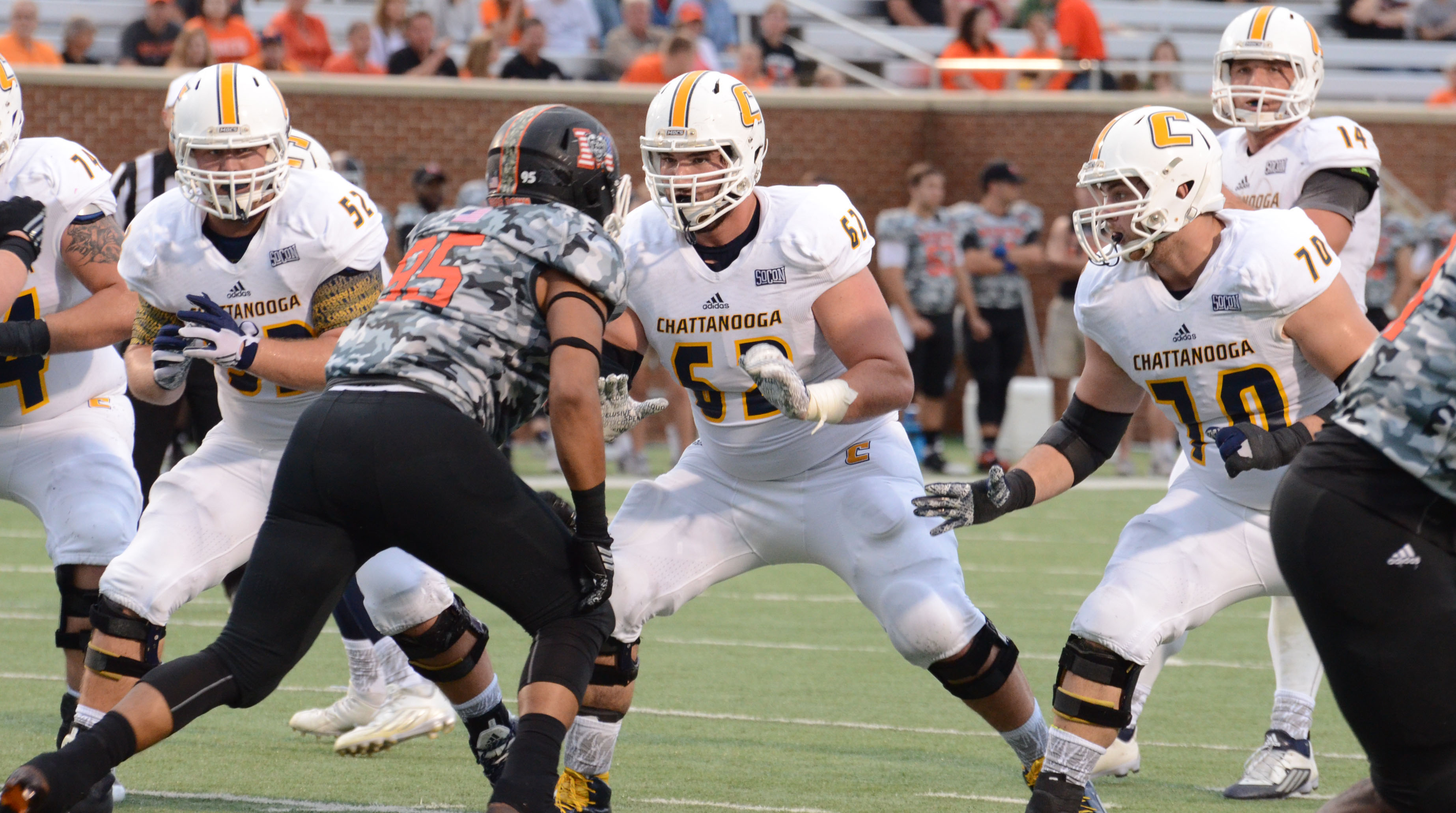 UTC's Corey Levin (62) against Mercer 
and (70) Hunter Towson, (52) Jacob Revis