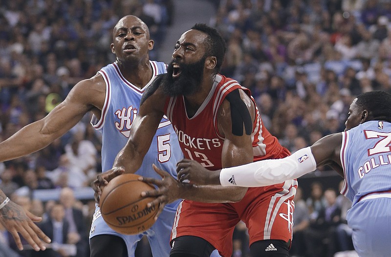
              Houston Rockets guard James Harden, center, drives to the basket between Sacramento Kings' James Anderson, left and Darren Collison during the first quarter of an NBA basketball game in Sacramento, Calif., Friday, Nov. 6, 2015. (AP Photo/Rich Pedroncelli)
            