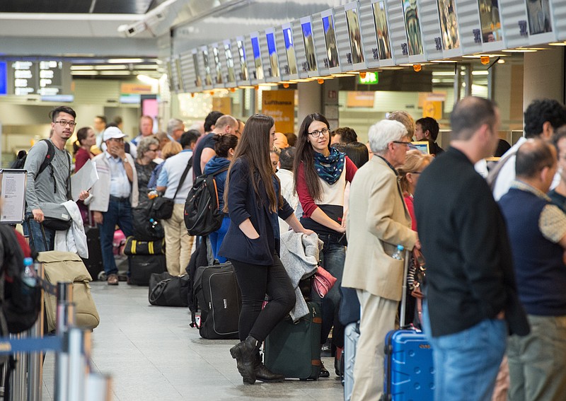 
              Passengers queue  in front of Lufthansa counters at the airport in Frankfurt, Germany, Saturday Nov. 7, 2015. Cabin crew at Lufthansa are staging a second day of strikes, forcing the German airline to cancel some 520 short- and medium-haul flights. The UFO union called members working on Airbus A320 and Boeing 737 planes at Lufthansa's main Frankfurt hub out on strike for 17 hours starting at 6 a.m. Saturday, along with cabin crew based in Duesseldorf, Germany.   (Boris Roessler/dpa via AP)
            