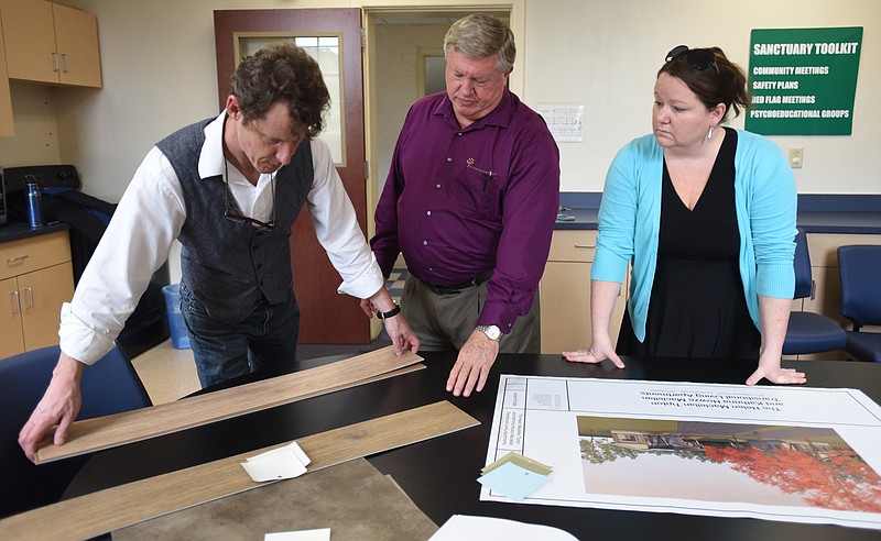 Architect Wayne Williams, Phil Acord, President/CEO of the Children's Home/Chambliss Shelter, and Liz Blasbery, executive director of resident services, from left, discuss materials and colors for a new facility while meeting Monday, November 2, 2015, at the Children's Home/Chambliss Shelter.