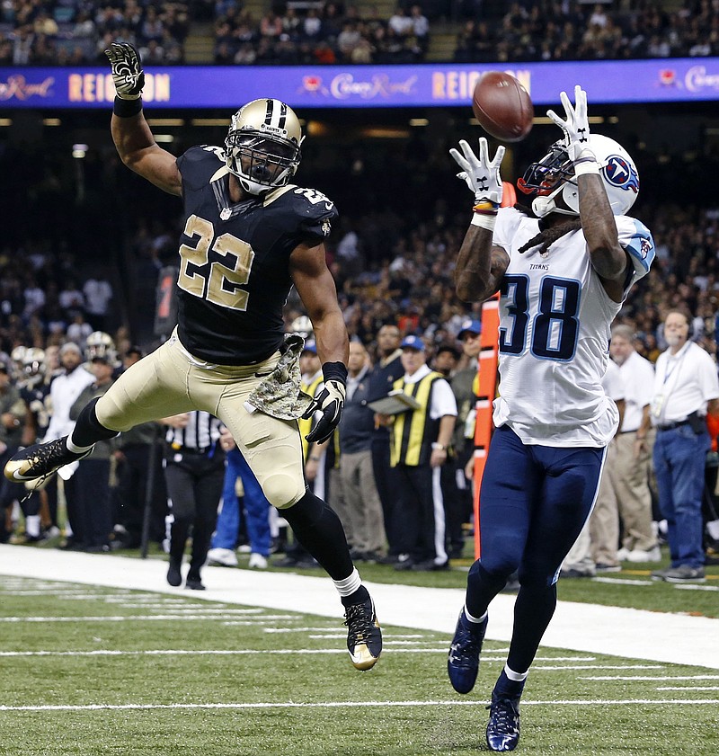 Tennessee Titans cornerback B.W. Webb (38) pulls in an interception on a pass intended for New Orleans Saints running back Mark Ingram (22) in the second half of an NFL football game in New Orleans, Sunday, Nov. 8, 2015. (AP Photo/Jonathan Bachman)