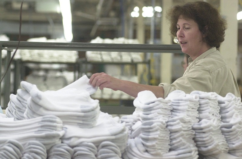 In this 2003 file photo, Denise Eldridge pairs socks Monday at the Cherokee Hosiery Mill in Fort Payne, Alabama. Fort Payne was once known as the sock capital of America.