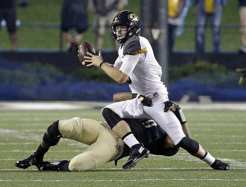 The University of Missouri football team, whose quarterback Drew Lock (3) is being sacked in a game earlier this year by Vanderbilt lineback Landon Stokes, threatened to boycott the rest of its season unless the school's president paid more attention to several racial incidents.