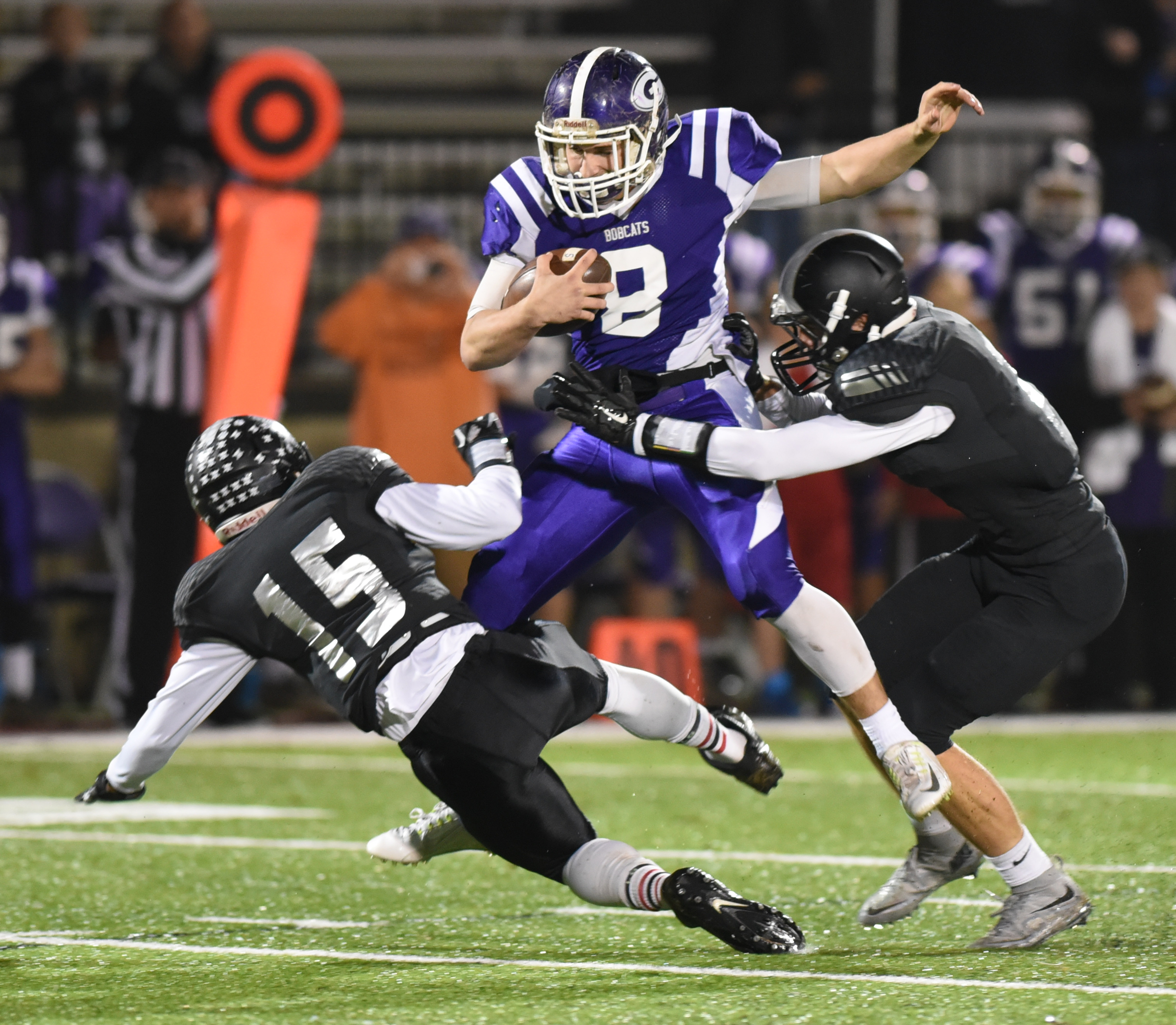 Gilmer County's Lucas Bramlett is tackled by Ridgeland's Markeion Jones, left, and Jeremy Masley Monday, November 9, 2015 at Christian Heritage School.