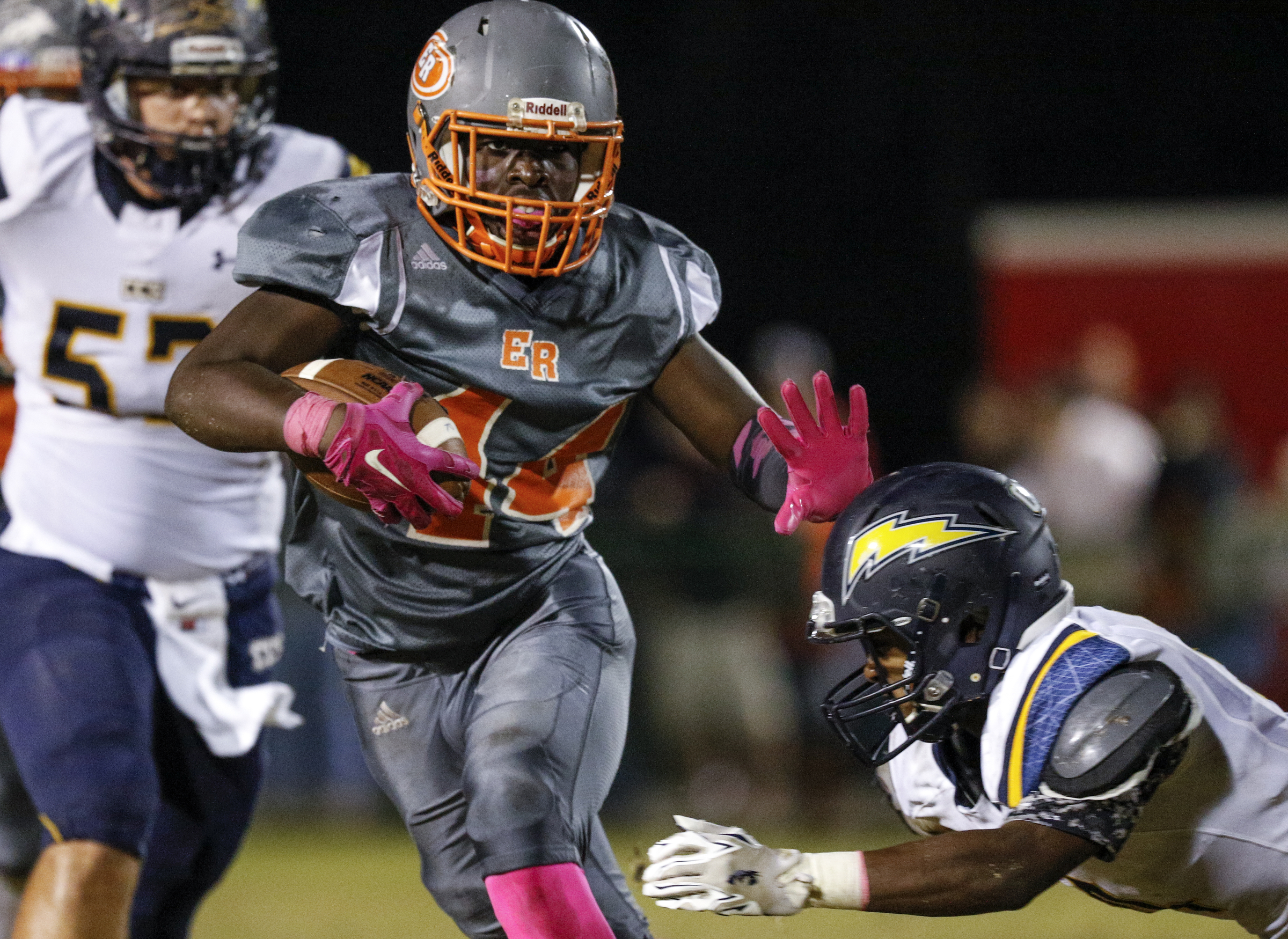 East Ridge running back Lorenzo Stewart stiff-arms CCS defender Brandon Mason during their prep football game at East Ridge High School on Friday, Oct. 30, 2015, in East Ridge, Tenn.