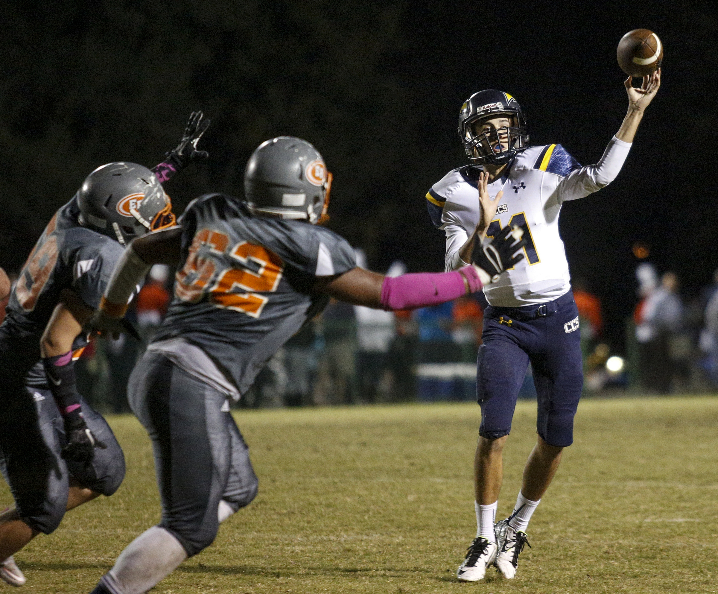 CCS quarterback Matthew Mercer passes under pressure from East Ridge's Tra Hubbard during their prep football game at East Ridge High School on Friday, Oct. 30, 2015, in East Ridge, Tenn.