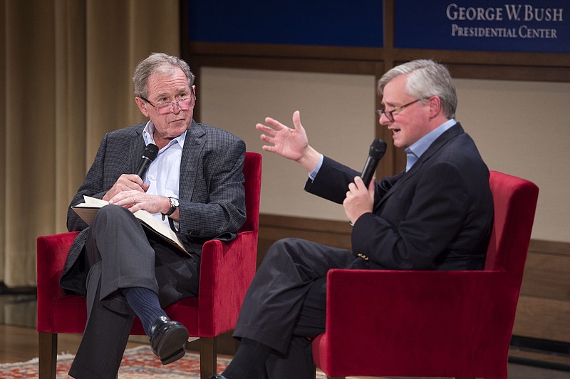 
              Former President George W. Bush, left, listens to Pulitzer Prize winning author Jon Meacham, right, talk about his biography of Bush's father, former President George H. W. Bush, Sunday, Nov. 8, 2015 at the George W. Bush Presidential Center in Dallas. (AP Photo/Jeffrey McWhorter)
            