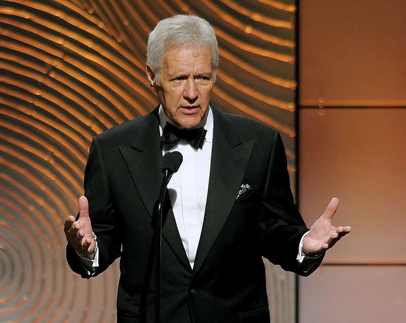 
              FILE - In a Sunday, June 16, 2013 file photo, Jeopardy! host Alex Trebek speaks on stage at the 40th Annual Daytime Emmy Awards, in Beverly Hills, Calif. "Jeopardy!" and "Wheel of Fortune", in cooperation with the veterans' support campaign Got Your 6, are using the week of Nov. 9, 2015 episodes to spotlight those who have served. (Photo by Chris Pizzello/Invision/AP, File)
            