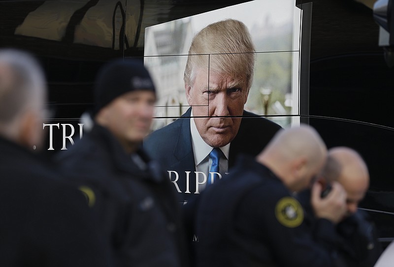 Police gather in front of Donald Trump's bus outside of the Milwaukee Theatre before a Republican presidential debate Tuesday, Nov. 10, 2015, in Milwaukee. 