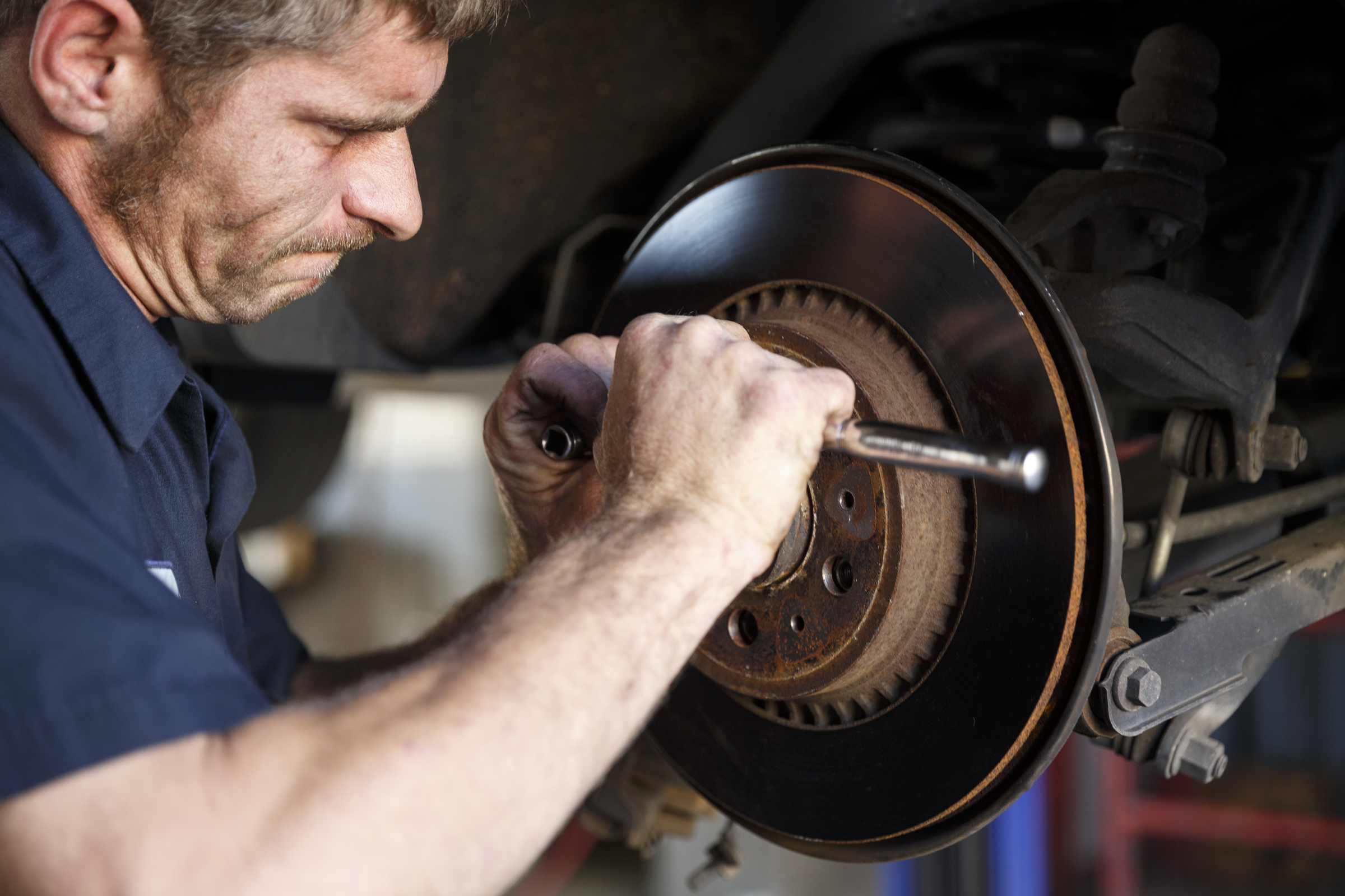 Mechanic Travis Brown reattaches a brake disc at Market Street Tire & Auto on Wednesday, Nov. 11, 2015, in Chattanooga, Tenn. The business is preparing to close for 6-8 weeks before returning as a corporate Firestone Tire location.