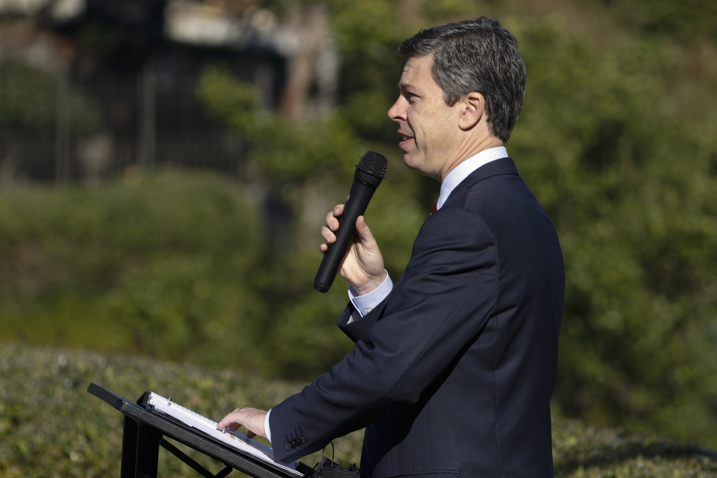 Staff Photo by Dan Henry / The Chattanooga Times Free Press- 11/11/15. Chattanooga Mayor Andy Berke speaks to patriots and officials during a flag raising ceremony in the Bluff View River Gallery Sculpture Garden in honor of Veterans Day on Wednesday, November 11, 2015. Five flags will be permanently flown on Veteran's Bridge in honor of the military personnel lost earlier this year.