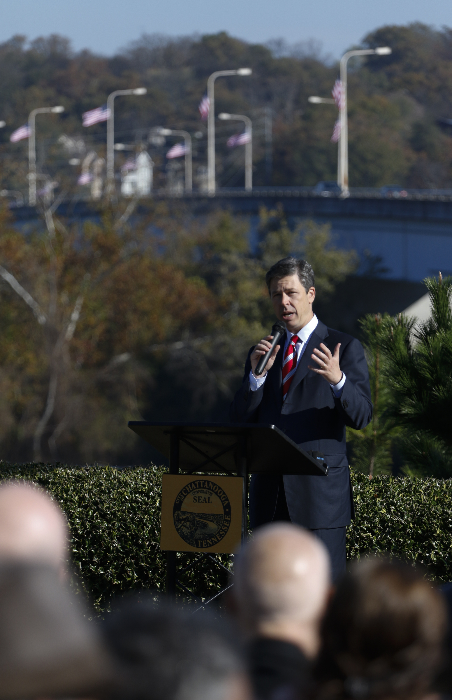 Staff Photo by Dan Henry / The Chattanooga Times Free Press- 11/11/15. Chattanooga Mayor Andy Berke speaks to patriots and officials during a flag raising ceremony in the Bluff View River Gallery Sculpture Garden in honor of Veterans Day on Wednesday, November 11, 2015. Five flags will be permanently flown on Veteran's Bridge in honor of the military personnel lost earlier this year.