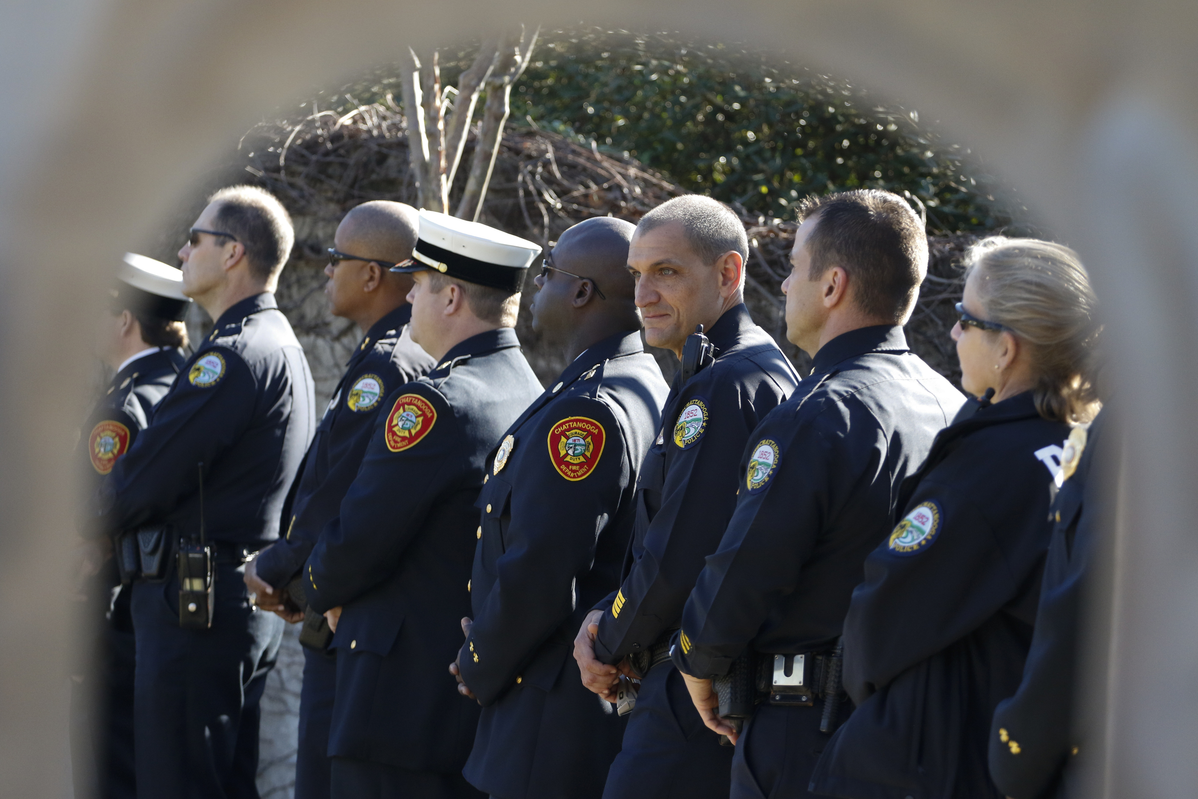 Staff Photo by Dan Henry / The Chattanooga Times Free Press- 11/11/15. Chattanooga Police Chief Fred Fletcher, center, and other officers listen as Chattanooga Mayor Andy Berke speaks to patriots and officials during a flag raising ceremony in the Bluff View River Gallery Sculpture Garden in honor of Veterans Day on Wednesday, November 11, 2015. Five flags will be permanently flown on Veteran's Bridge in honor of the military personnel lost earlier this year.