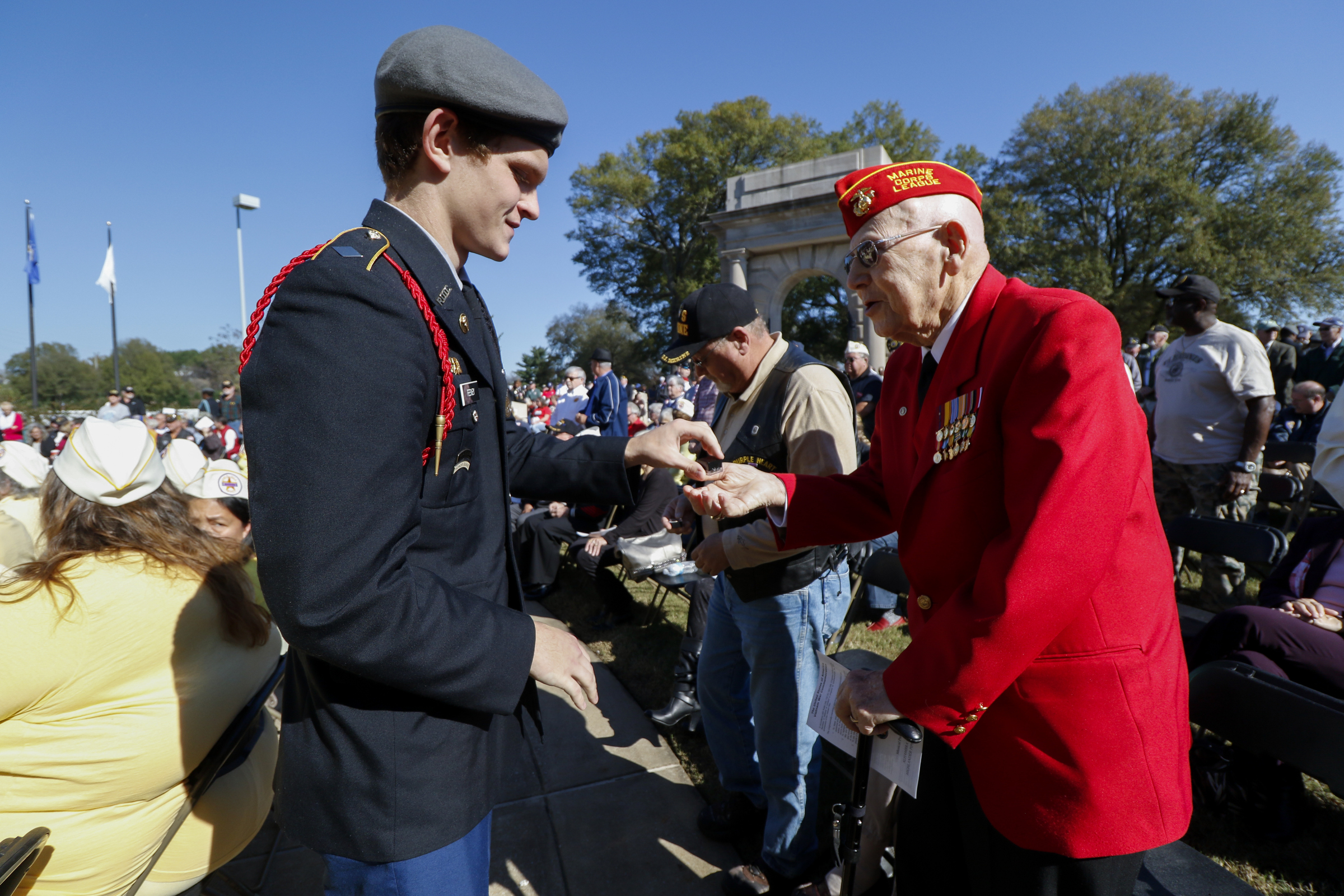 Staff Photo by Dan Henry / The Chattanooga Times Free Press- 11/11/15. Red Bank High School JROTC Cadet Shane Feeney hands Master Sgt. Robert S Clark a special pin during a Veteranճ Day tribute on November, 11, 2015 at the Chattanooga National Cemetery Armed Forces Pavillon. The Chattanooga National Cemetery and the Chattanooga Area Veterans Council hosted the event.