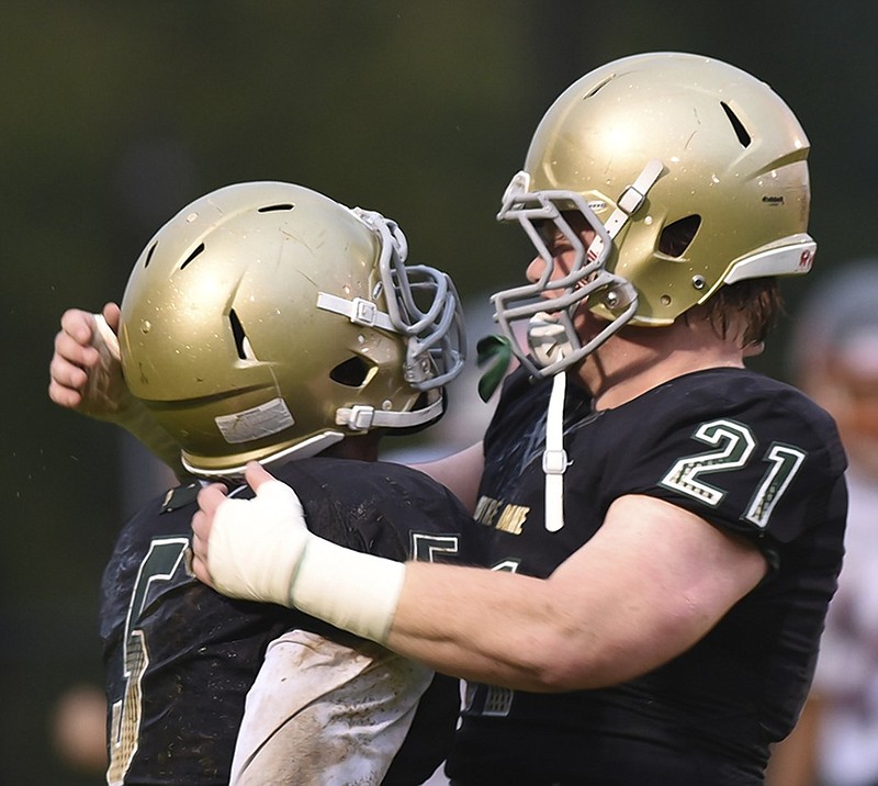 Notre Dame's Tyler Enos, right, congratulates teammate Ricky Ballard after a score during their game against East Ridge this season.