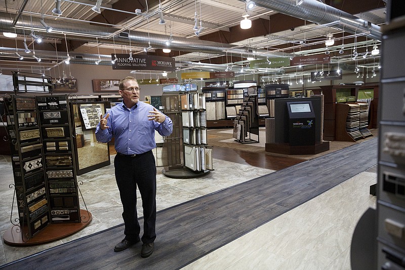 Engineering manager Kent Thomas talks in the showroom of the new LEED gold-certified building at Mohawk Flooring Center on Thursday in Calhoun, Ga. Mohawk cut the ribbon Thursday on its new building at its Calhoun campus.