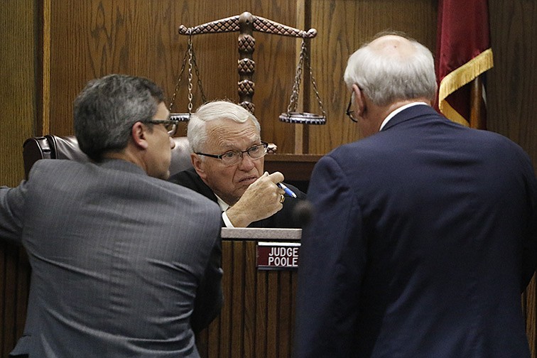Hamilton County District Attorney General Neal Pinkston, left, talks with defense attorney Jimmy Logan, right and Judge Don Poole during a recent case.