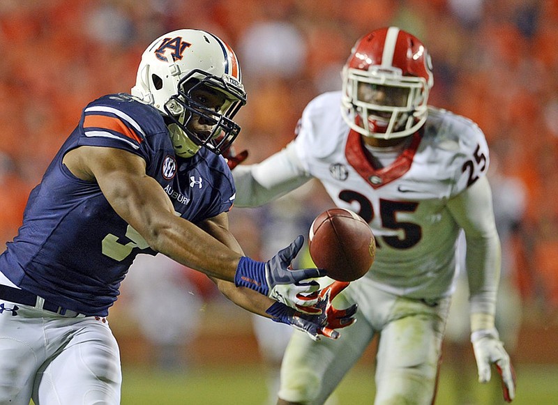Auburn receiver Ricardo Louis came up with a miraculous 73-yard touchdown reception in a 43-38 win over Georgia in 2013 after former Bulldogs safety Josh Harvey-Clemons (25) collided with a teammate.