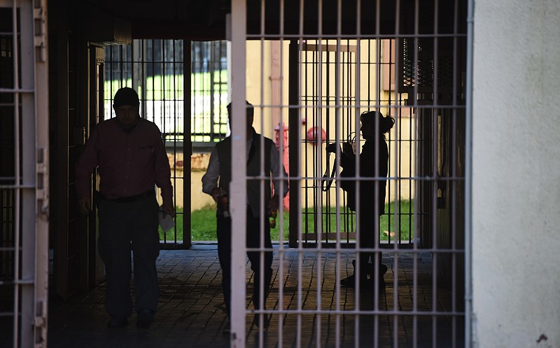 Developer Brian May, center, leads a tour of Brushy Mountain State Penitentiary in Petros on Wednesday, Nov. 11, 2015. May, Pete Waddington, and Tom Poteet of the Brushy Mountain Group are planning to install a distillery at the now-defunct prison site, along with offering tours and other tourist activities. (ADAM LAU/NEWS SENTINEL)