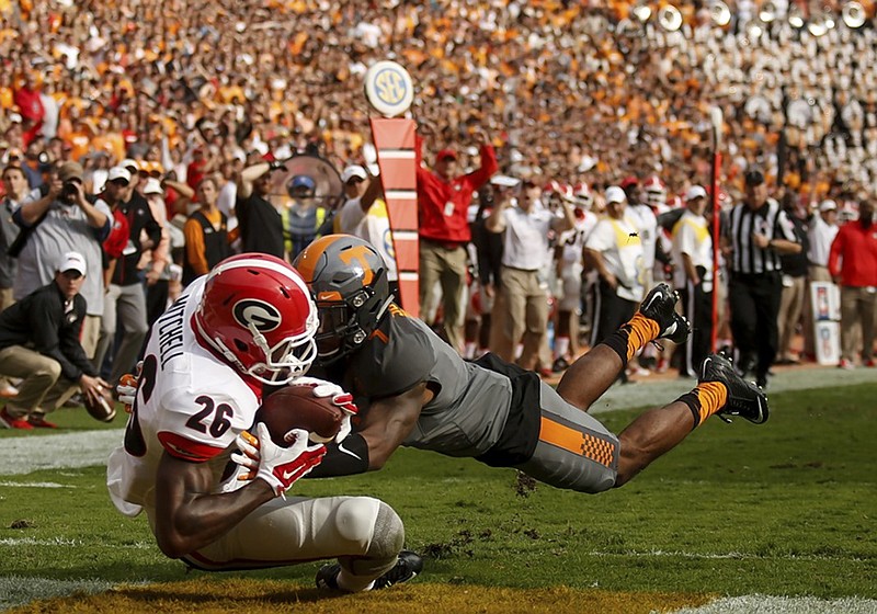 Tennessee cornerback Cameron Sutton tackles Georgia receiver Malcolm Mitchell as he catches a touchdown pass during last month's game in Knoxville.