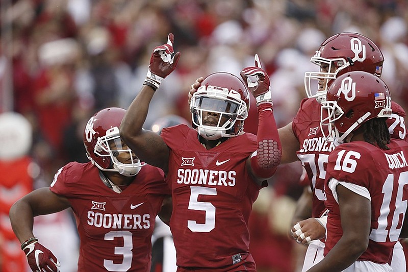 Oklahoma wide receiver Durron Neal (5) celebrates after scoring a touchdown during a 63-27 home win against Texas Tech last month. The Sooners are 8-1 and have scored at least 52 points in each of their past four games, part of the reason many college football fans have deemed them the most complete team in the Big 12. But better than Baylor at home? Think carefully about that pick, writes columnist Jay Greeson.