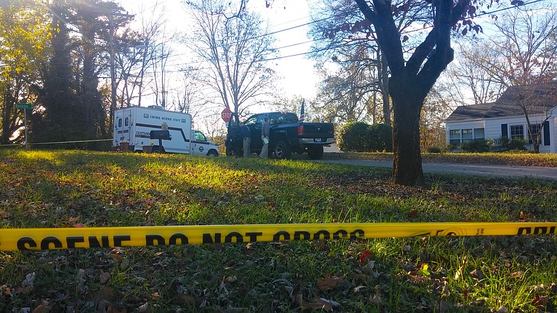 Investigators examine a truck at the homicide scene.