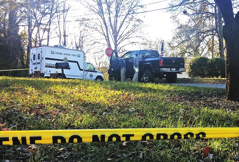 Chattanooga police investigators examine a truck in the 400 block of Frazier Drive in Brainerd, where a 21-year-old man was shot to death around 4 a.m. Friday morning. Photo By Shelly Bradbury