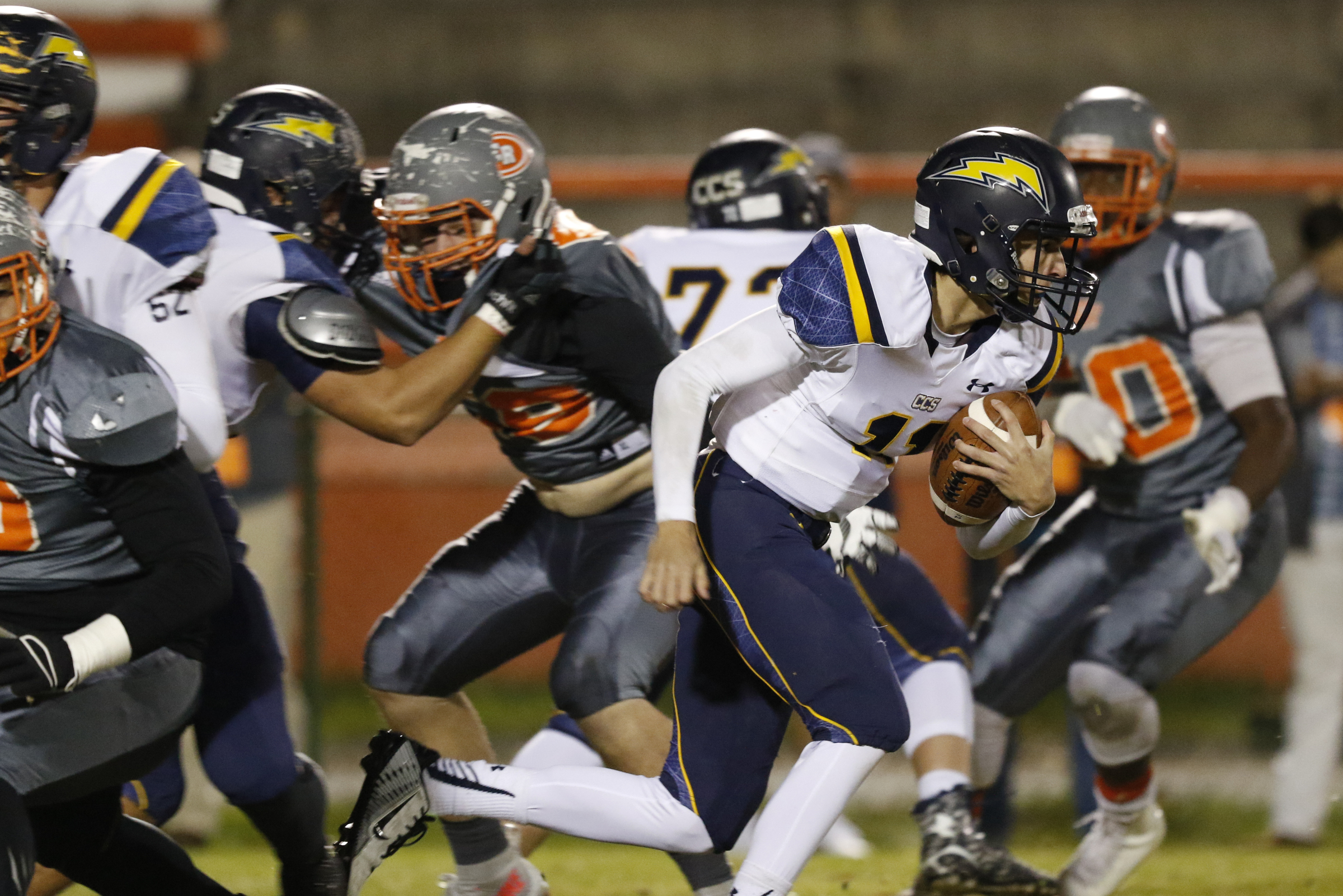 *Staff Photo by Dan Henry / The Chattanooga Times Free Press- 11/13/15. Chattanooga Christian's Matthew Mercer (11) runs the ball past the East Ridge defensive line at the Pioneer's home field on Friday, November 13, 2015.