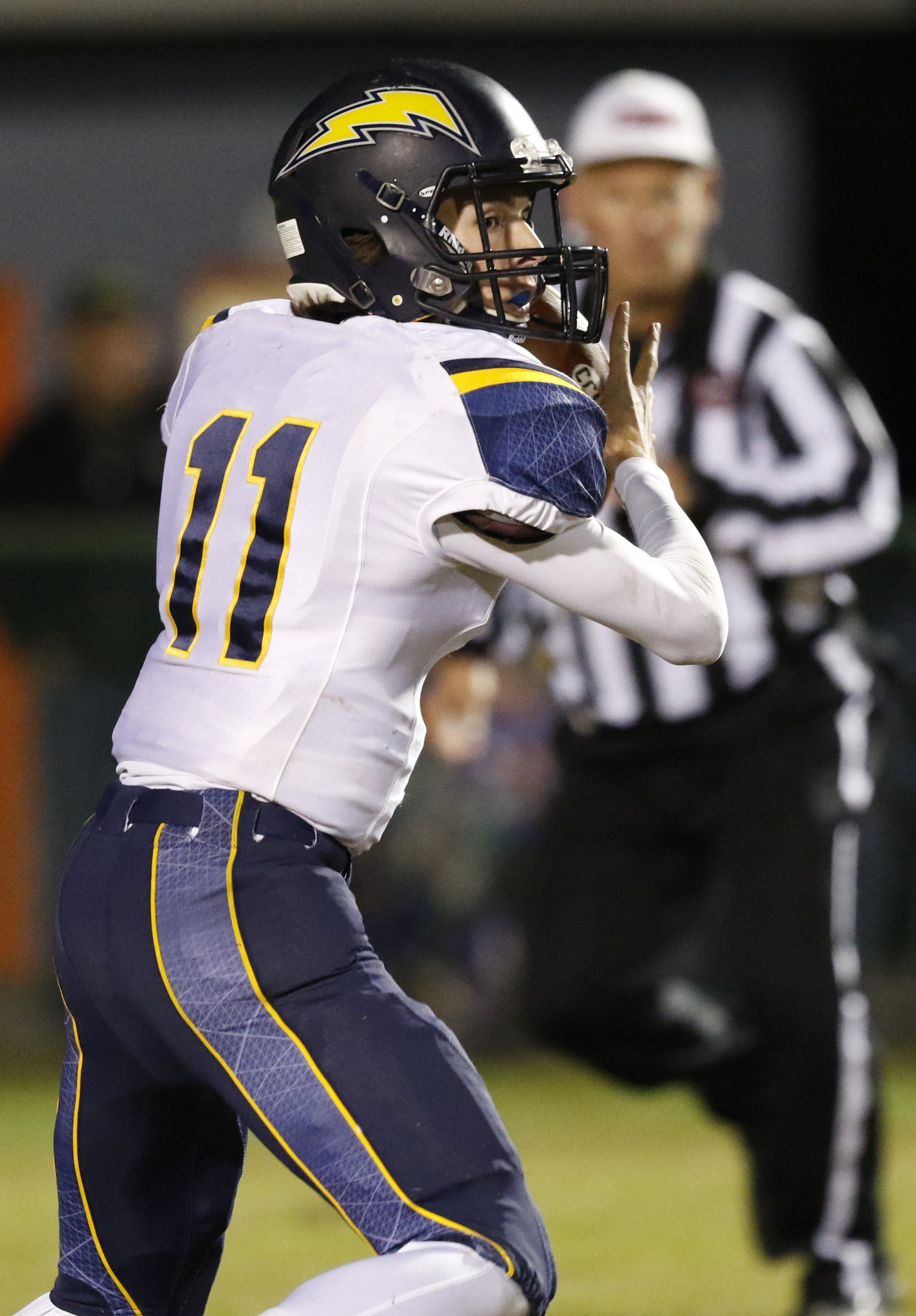 *Staff Photo by Dan Henry / The Chattanooga Times Free Press- 11/13/15. Chattanooga Christian quarterback Matthew Mercer (11) recovers a bad snap before looking to get rid of the ball while playing East Ridge at the Pioneer's home field on Friday, November 13, 2015.