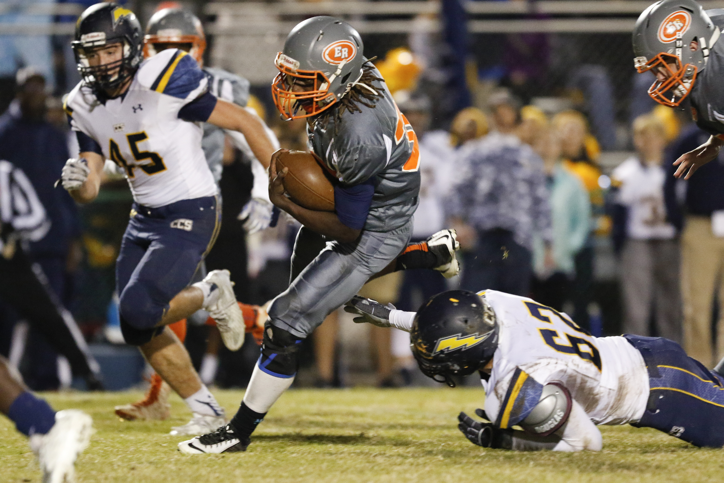 East Ridge running back Traneil Moore (32) runs the ball past Chattanooga Christian's Brandon Bain and in to score the first touchdown of the game at the Pioneer's home field on Friday, November 13, 2015.