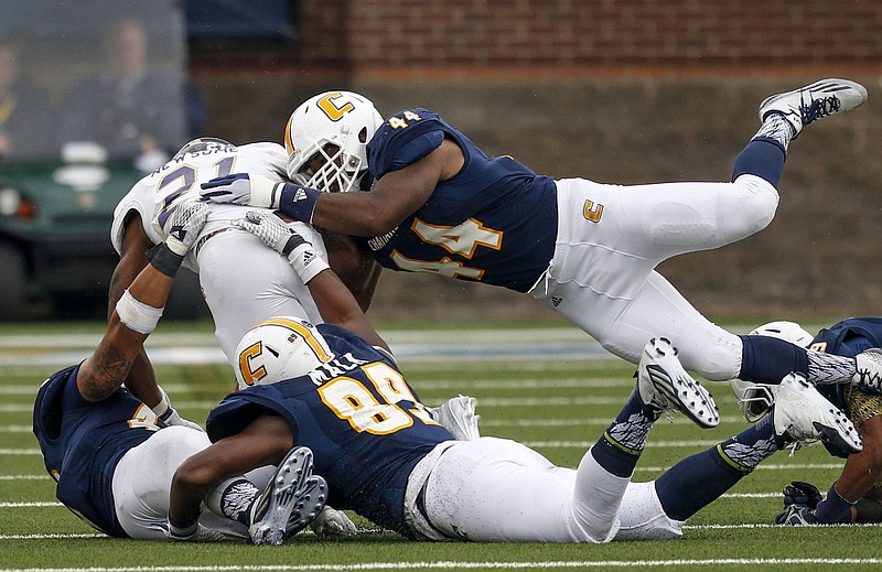 UTC defenders Toyvian Brand (44), Isaiah Mack (89) and A.J. Hampton tackle Western Carolina running back Detrez Newsome during the Mocs' rout of WCU on Oct. 31. The Mocs hope to match that day's performance today against the Citadel.