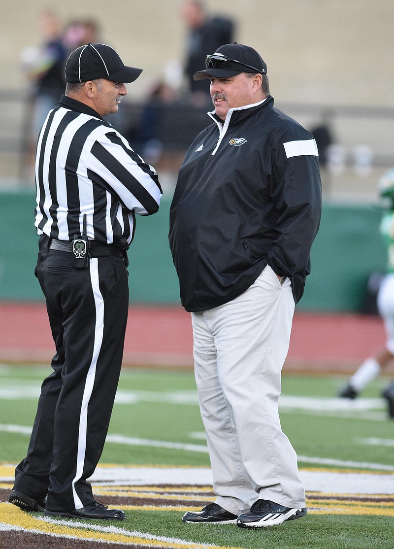 Rhea County coach Mark Pemberton talks with an official before the game last month against Soddy-Daisy. Rhea's Eagles beat Farragut 40-34 on Friday.