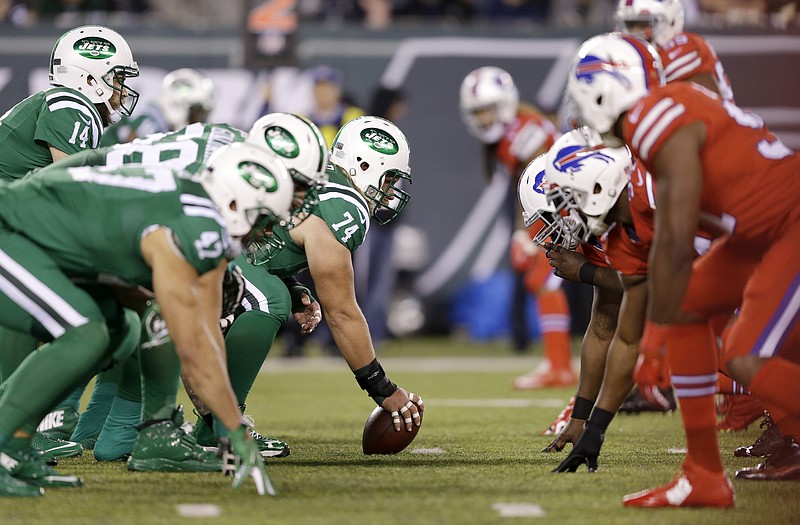 
              New York Jets quarterback Ryan Fitzpatrick, top left, prepares for the snap as his team lines up against the Buffalo Bills during the first half of an NFL football game, Thursday, Nov. 12, 2015, in East Rutherford, N.J. (AP Photo/Seth Wenig)
            