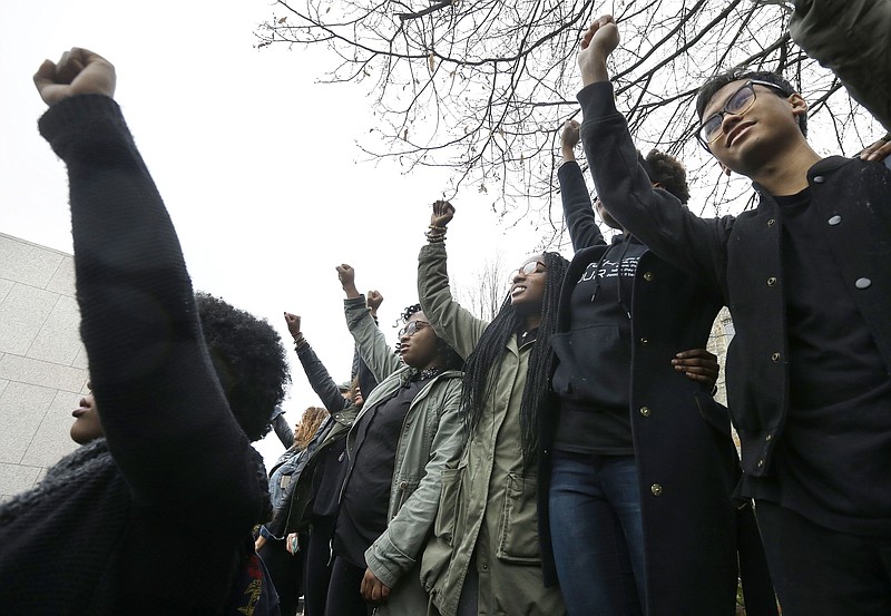 Students at Boston College raise their arms during a solidarity demonstration on the school's campus Thursday, Nov. 12, 2015, in Newton, Mass. The protest was among numerous campus actions around the country following the racially charged strife at the University of Missouri.