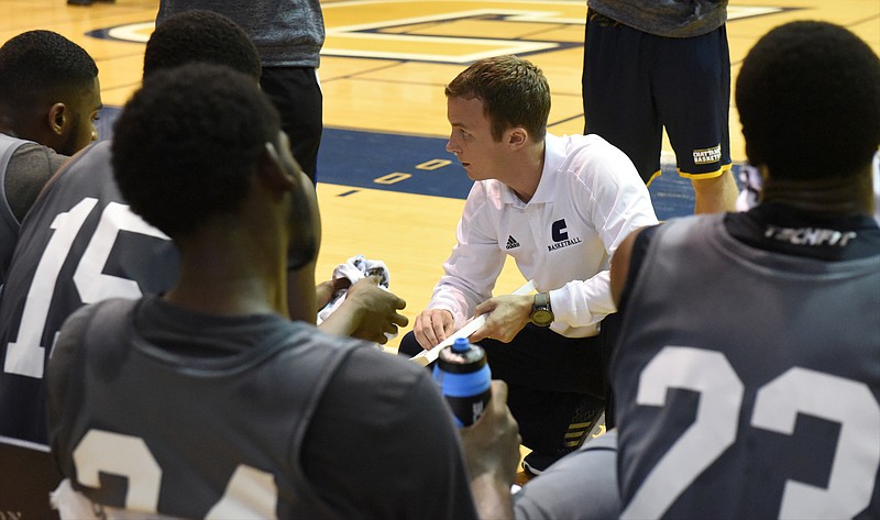 Coach Matt McCall talks to his players on the bench during a time out as the UTC men's basketball team holds a scrimmage at Maclellan Gym on Sunday, Oct. 25, 2015, in Chattanooga.