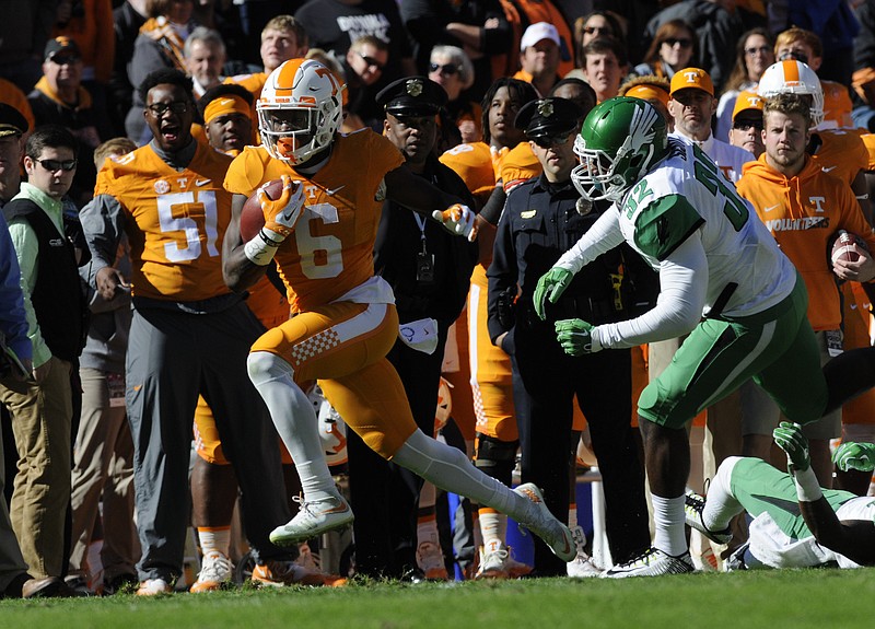 Tennessee's Alvin Kamara breaks free of North Texas' Fred Scott and scores early in the first quarter Saturday at Neyland Stadium.