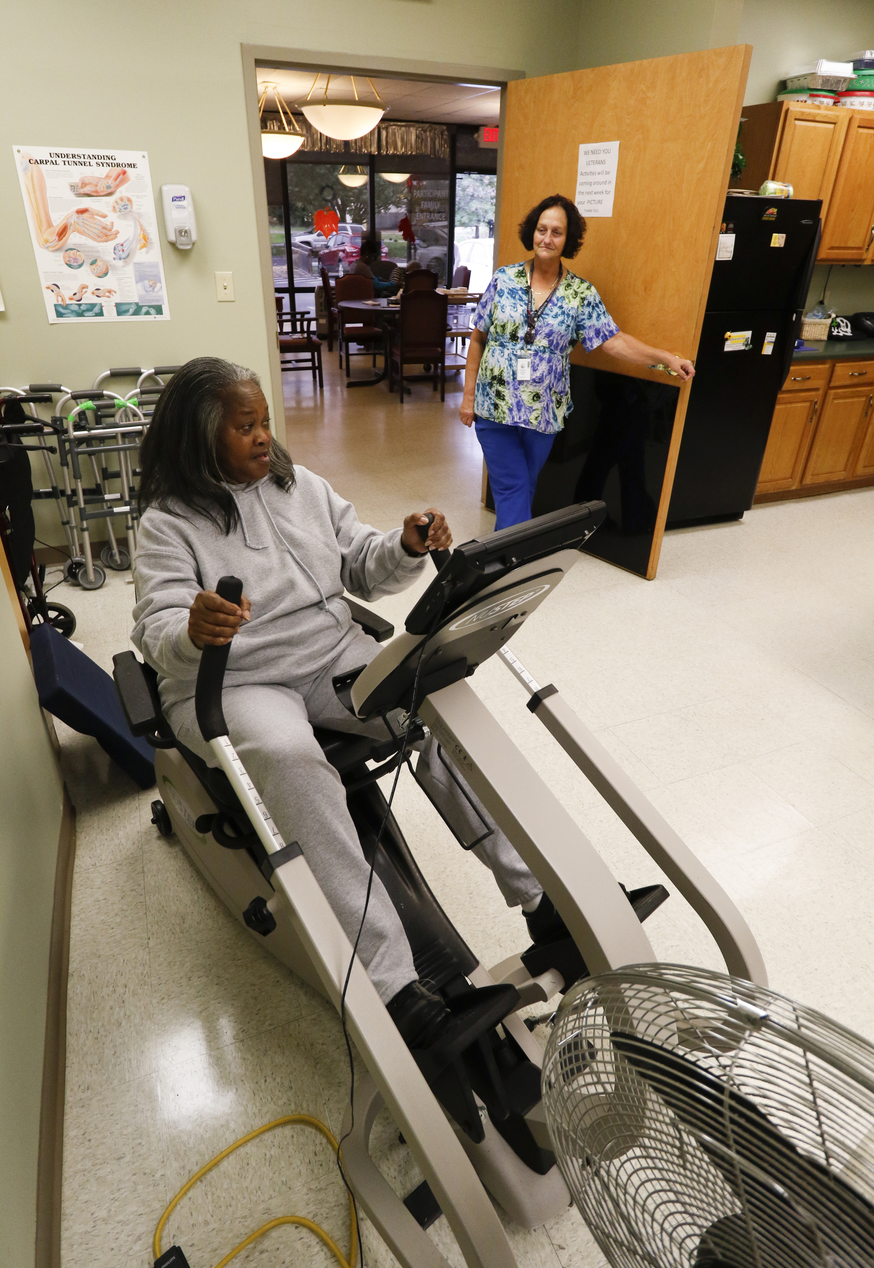 Staff Photo by Dan Henry / The Chattanooga Times Free Press- 11/5/15. Martha Sims works out as Sandra Gaston supervises her adult daycare client while at the Alexian Brothers Community Services facility off of Cumberland Street in downtown Chattanooga on Wednesday, November 4, 2015.