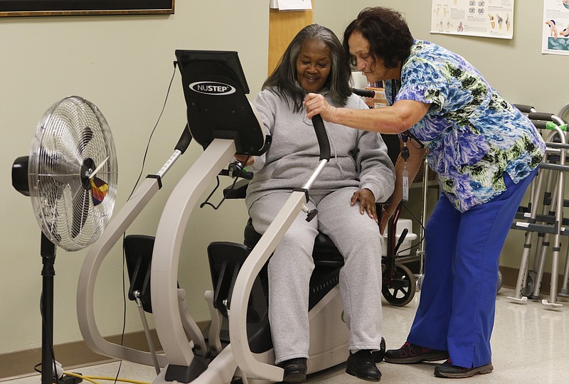 Staff Photo by Dan Henry / The Chattanooga Times Free Press- 11/5/15. Martha Sims works out as Sandra Gaston supervises her adult daycare client while at the Alexian Brothers Community Services facility off of Cumberland Street in downtown Chattanooga on Wednesday, November 4, 2015.