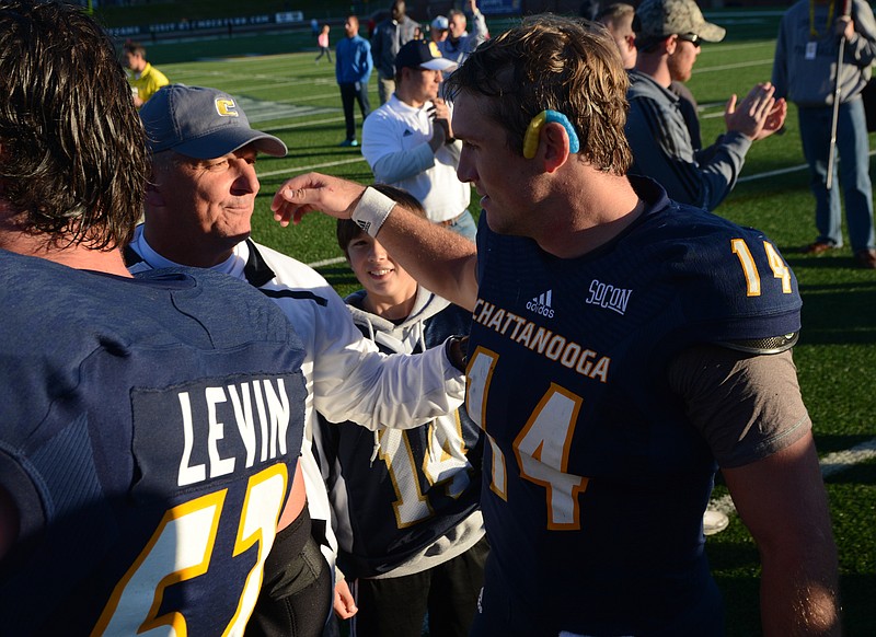 Coach Russ Huesman hugs his son, quarterback Jacob Huesman, after the Mocs beat the Citadel on Saturday, Nov. 14, 2015, in Chattanooga, Tenn., by a score of 31-17.