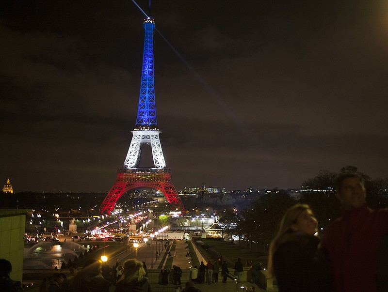 The Eiffel Tower lit up again Monday with national colors three days after terrorist attacks in Paris last week.