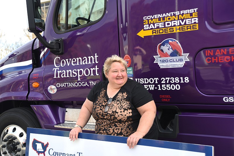 Renae Dohrer stands next to her new purple truck at Covenant Transport Monday, November 16, 2015, after an event to honor her for reaching three million consecutive and accident-free miles with the company.