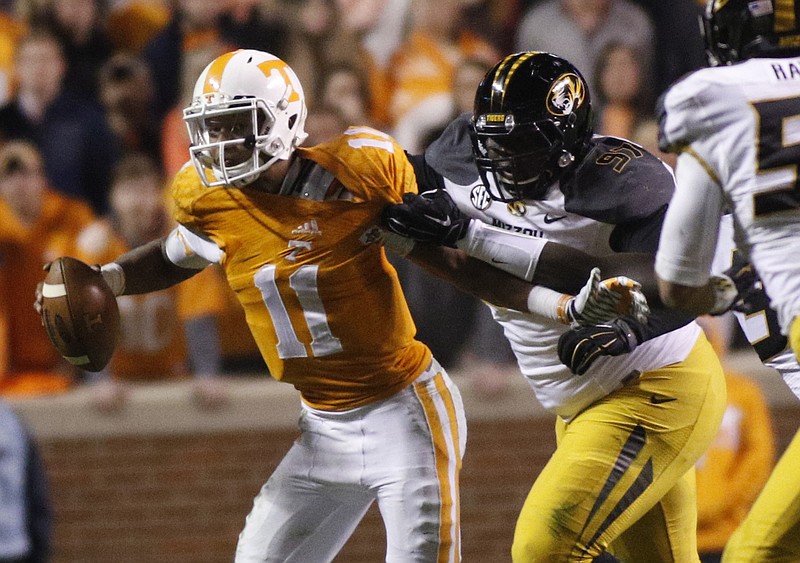 Tennessee quarterback Joshua Dobbs breaks away from Missouri defensive lineman Josh Augusta during the Vols' 29-21 loss to the Missouri Tigers on Saturday, Nov. 22, 2014, at Neyland Stadium in Knoxville, Tenn.