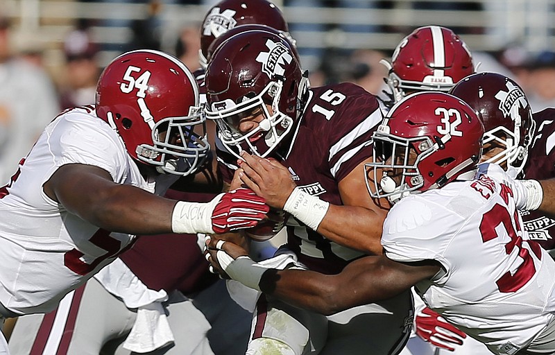 Alabama defensive lineman Dalvin Tomlinson (54) and linebacker Rashaan Evans (32) helped limit Mississippi State quarterback Dak Prescott to 14 rushing yards in the Crimson Tide's 31-6 win this past Saturday.