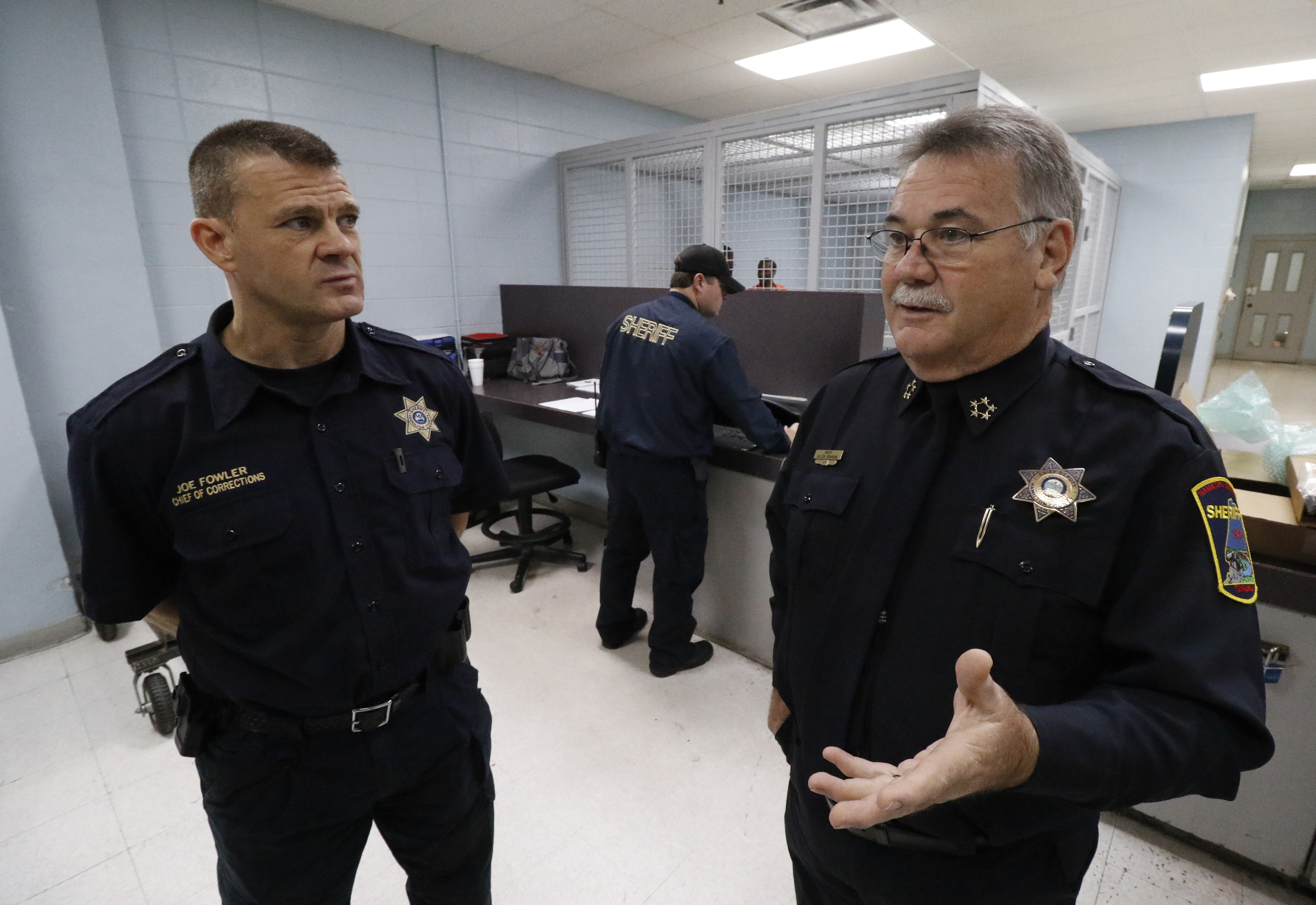 Joe Fowler, Chief of Corrections, left, and Chief Allen Branum speak about a new video kiosk that will be used for all visitation for inmates at the jail in downtown Chattanooga.
