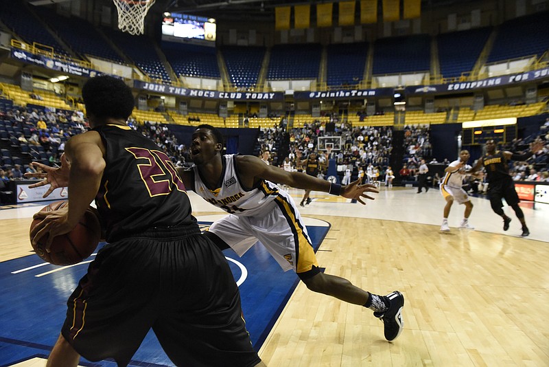 UTC's Casey Jones defends the inbound pass from Hiwassee's Jeulian High as the University of Tennessee at Chattanooga hosts Hiwassee College in a men's basketball game Monday, Nov. 16, 2015, in Chattanooga, Tenn. UTC won their home opener by a score of 94-55.