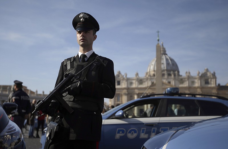 
              FILE - In this Sunday, Nov. 15, 2015 file photo, Italian Police and Carabinieri officers patrol in St. Peter's Square at the Vatican. Italy's top security official said Italy has heightened security inside Italy and along its borders, especially with France, following the attacks in Paris. While few in the war-weary West want to send ground troops to the areas controlled by Islamic State, it may actually be even harder to find anyone arguing that the aerial bombardment strategy will soon succeed in defeating the radical jihadi group. (AP Photo/Gregorio Borgia, File)
            