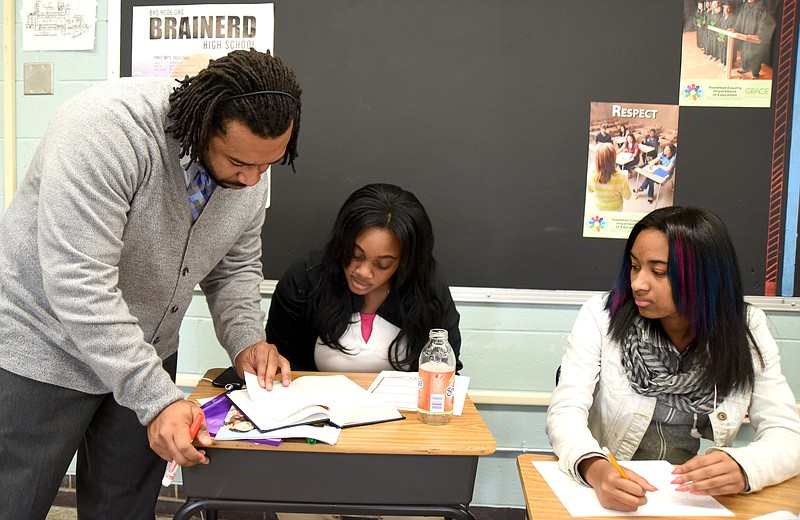 Teacher Quincy Harris talks with Sacia Willis, center, and Ja'mes Johnson in his Bible History class at Brainerd High School on Tuesday.