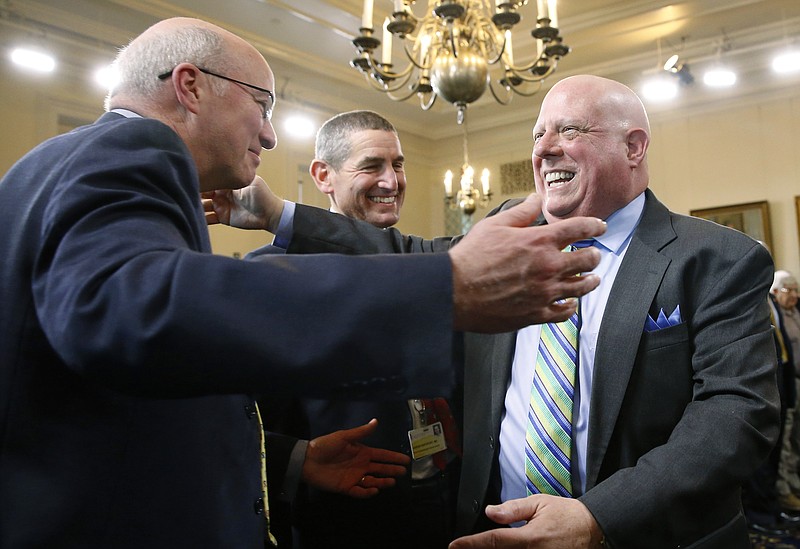 
              Maryland Gov. Larry Hogan, right, hugs the physicians who treated his cancer, Dr. Kevin Cullen, left, and Dr. Aaron Rapoport, after announcing that his cancer is in complete remission at a news conference in the Maryland State House, Monday, Nov. 16, 2015, in Annapolis, Md. Hogan, who was diagnosed with B-cell non-Hodgkin lymphoma in June, will continue to get scans on a regular basis and undergo preventive health maintenance. (AP Photo/Patrick Semansky)
            